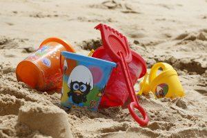 Image of beach with childrens buckets and spades depicting a family holiday