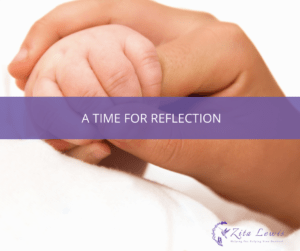 Photography of parent and baby hands entertwined and text overlay that says A Time for Reflection