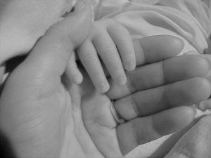 Image of a childs hand in an adults