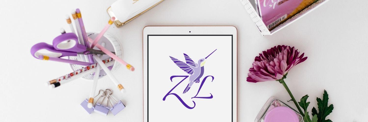 Photography of a pen pot, ipad and dark pink flower and the Zita Lewis hummingbird logo